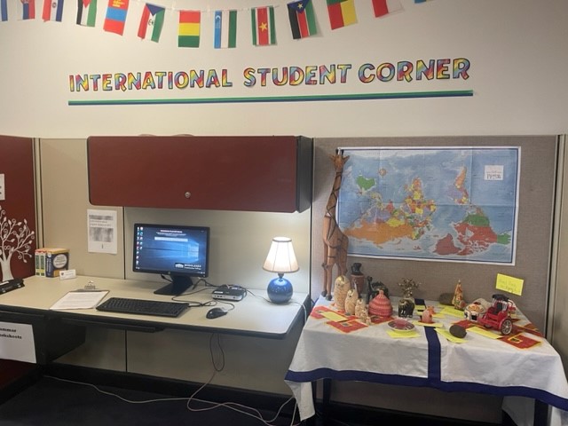 International Student Corner, a laptop on the table beside many artifacts from all over the world