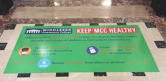 Sign on the floor of the Lowell Campus Federal Building Lobby.